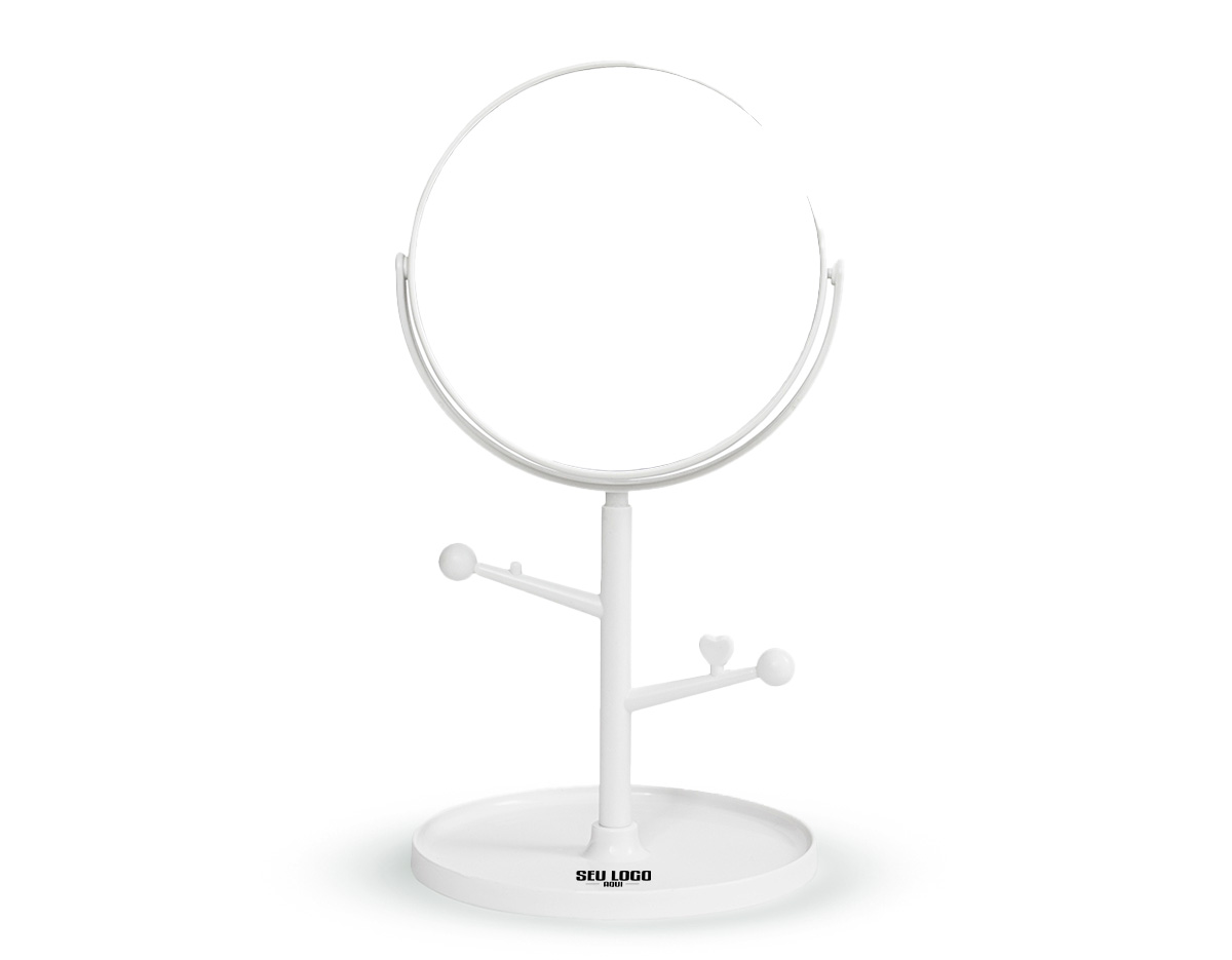 Espelho de mesa dupla face sem aumento. Possui estrutura em plástico com ganchos laterais e base circular para guardar pequenos objetos.